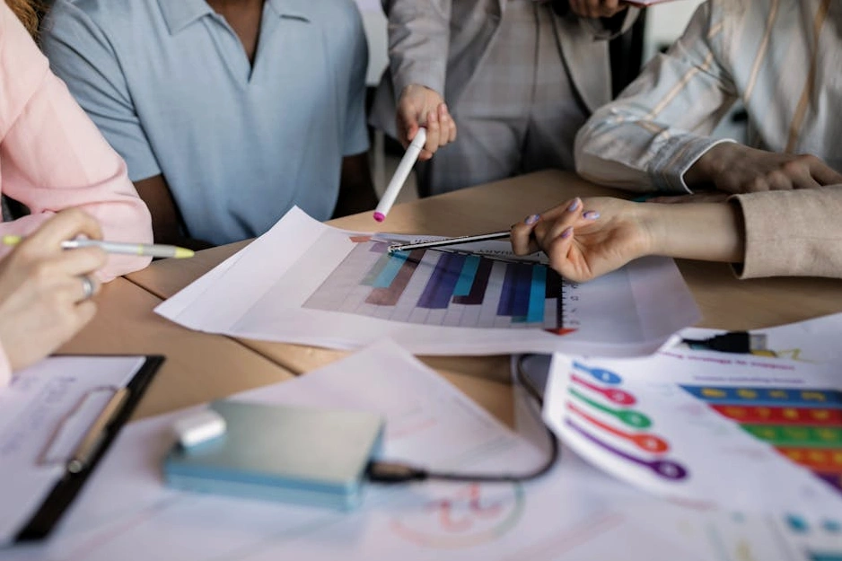 Zróżnicowany zespół ludzi współpracujących przy stole w jasnym biurze